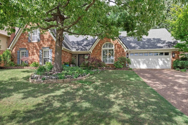 8792 E Carrollwood Ln E, Memphis, TN 38016 - view of front of house featuring brick siding, a garage, concrete driveway, a front lawn, and roof with shingles