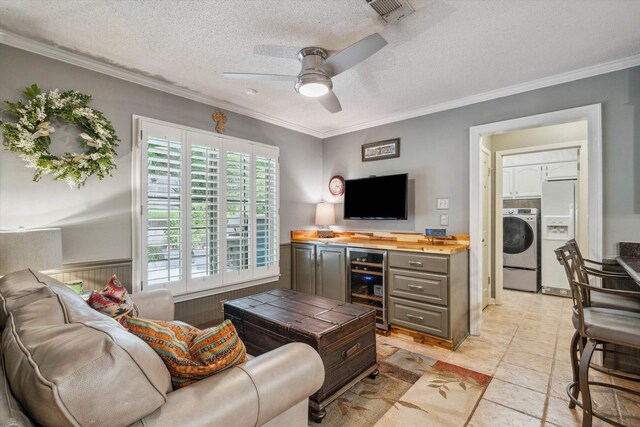 8792 E Carrollwood Ln E, Memphis, TN 38016 - living area with wine cooler, washer / dryer, crown molding, a ceiling fan, and a textured ceiling