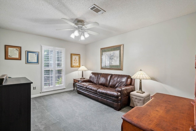 8792 E Carrollwood Ln E, Memphis, TN 38016 - carpeted living room featuring a ceiling fan, baseboards, and a textured ceiling