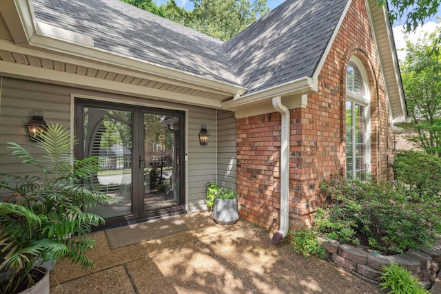 8792 E Carrollwood Ln E, Memphis, TN 38016 - property entrance featuring brick siding, roof with shingles, and french doors