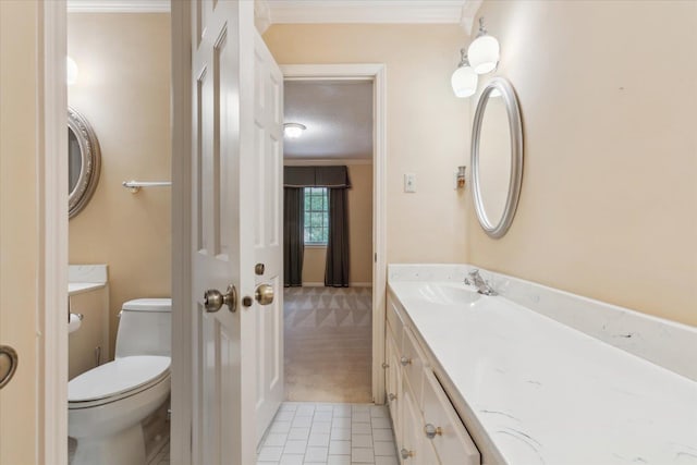 bathroom with crown molding, vanity, toilet, and a textured ceiling
