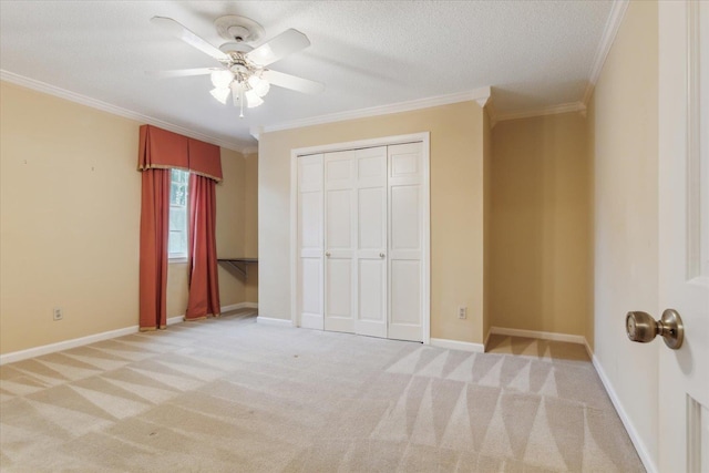 unfurnished bedroom featuring ornamental molding, light carpet, a closet, a textured ceiling, and ceiling fan