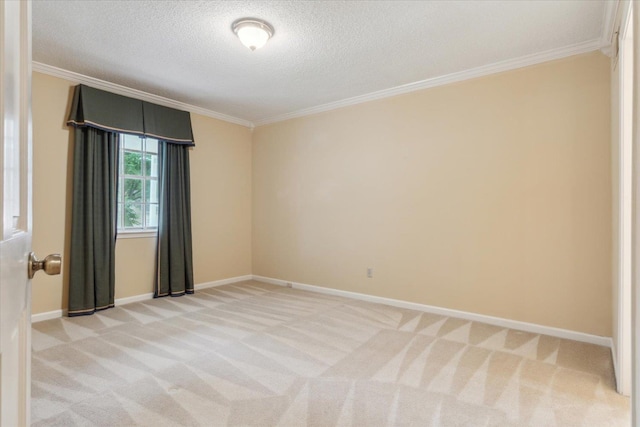 unfurnished room featuring ornamental molding, light carpet, a textured ceiling, and baseboards