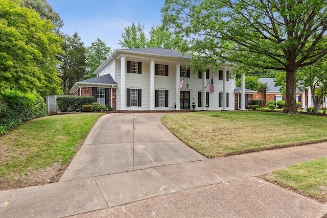 neoclassical home with covered porch and driveway