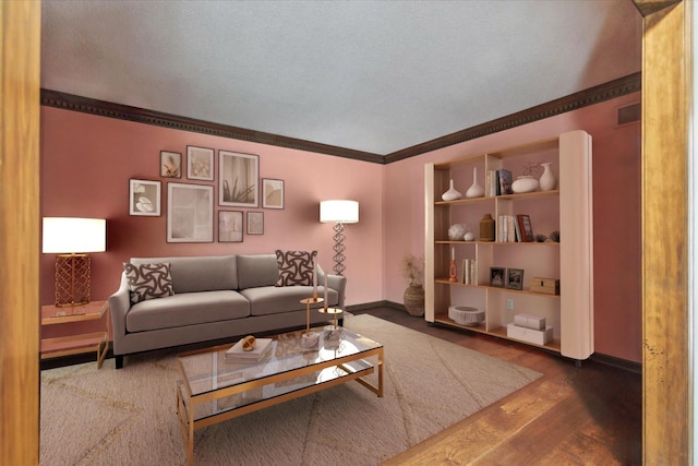 living area with crown molding, wood finished floors, and baseboards