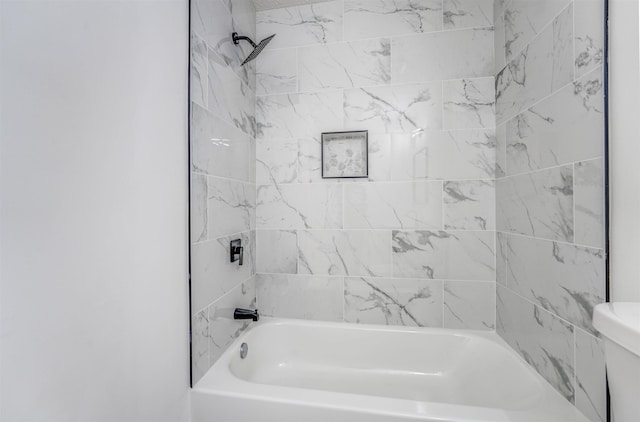 bathroom featuring shower / bathtub combination and toilet