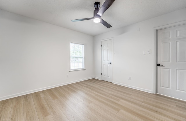 unfurnished bedroom featuring light wood finished floors, baseboards, and ceiling fan
