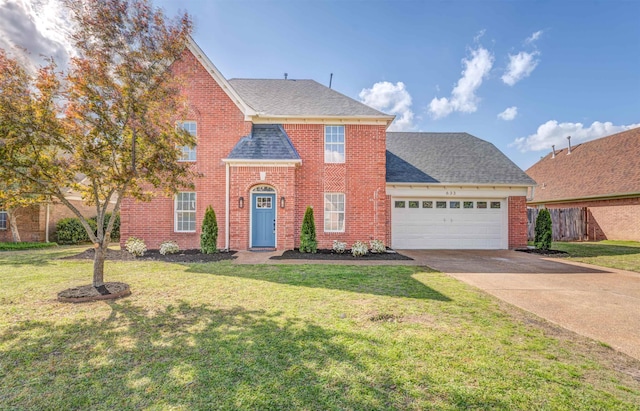 view of front of home with a garage, driveway, a front yard, and brick siding