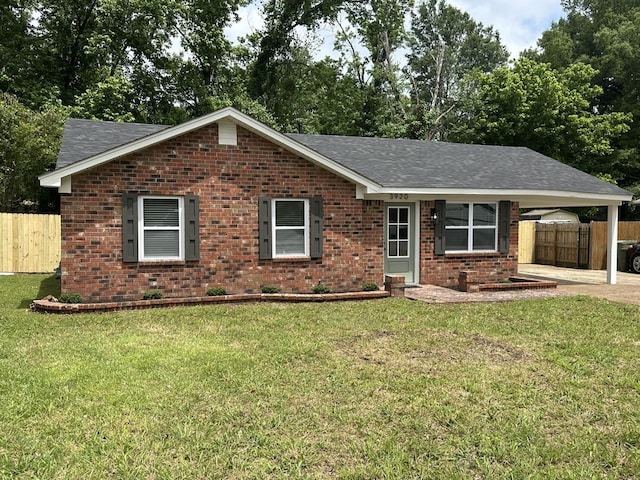 ranch-style house featuring brick siding, a carport, and roof with shingles