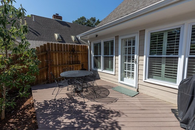 deck with outdoor dining space and fence