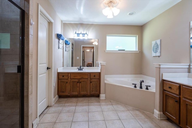 bathroom with a bath, tile patterned flooring, two vanities, and a stall shower