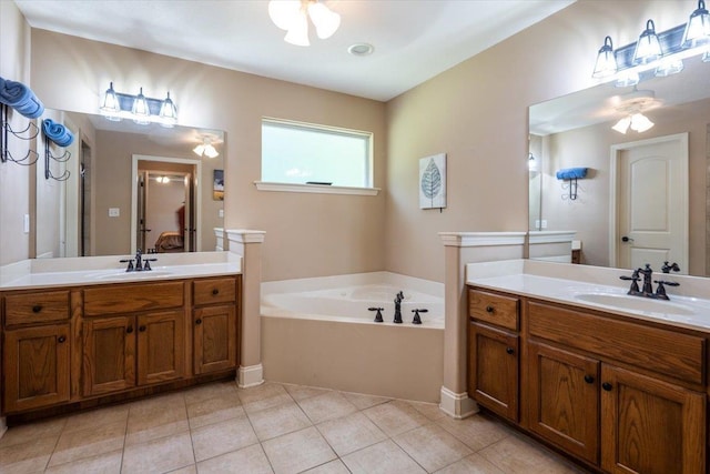 full bathroom with tile patterned flooring, a bath, two vanities, and ceiling fan