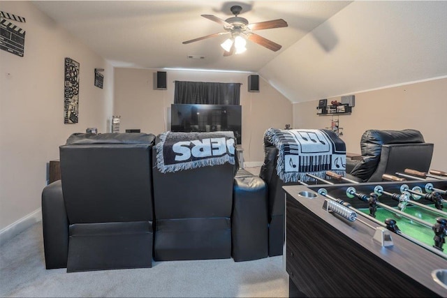 home theater featuring carpet, ceiling fan, baseboards, and vaulted ceiling