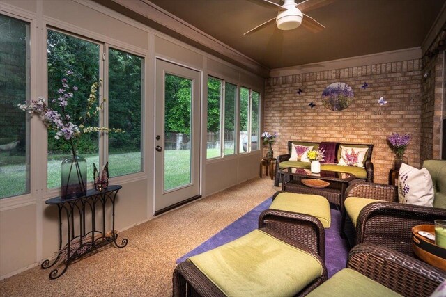 sunroom featuring carpet, a ceiling fan, outdoor lounge area, crown molding, and french doors