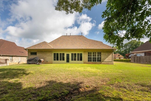 back of property featuring brick siding