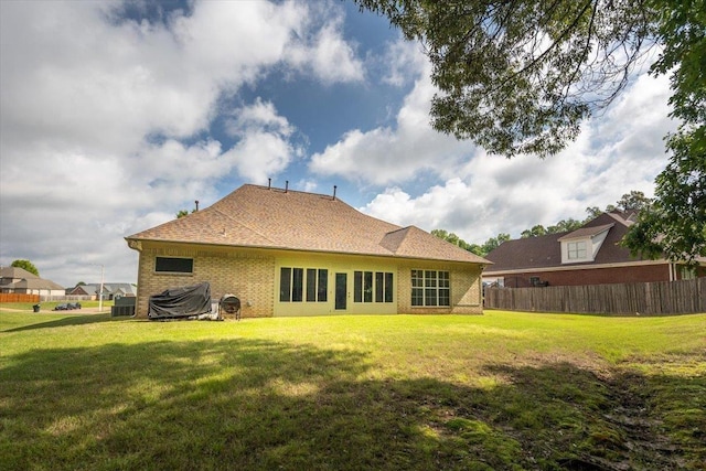 rear view of property with brick siding