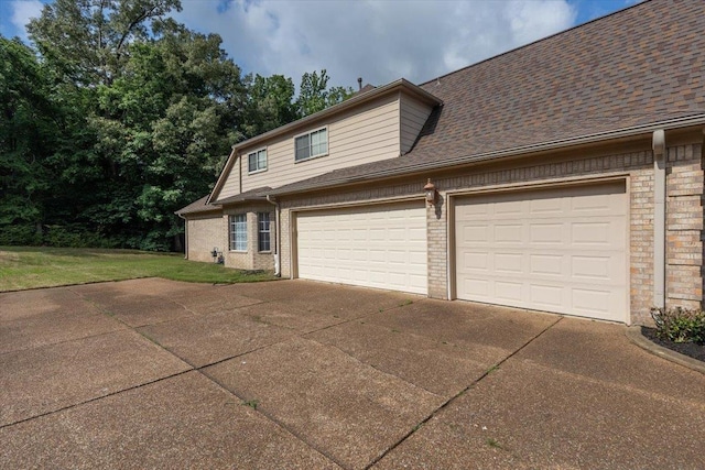 view of front of home with brick siding, driveway, an attached garage, and roof with shingles