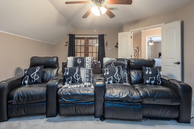 cinema room with ceiling fan, carpet flooring, and lofted ceiling