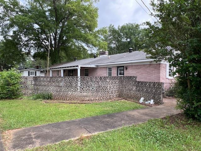 rear view of property with brick siding