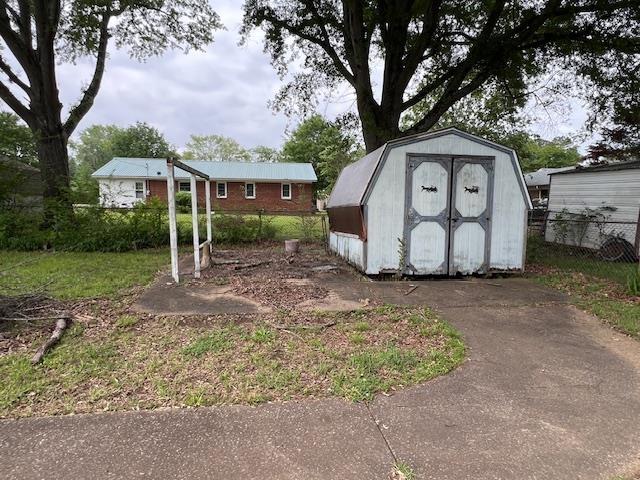 view of shed featuring fence