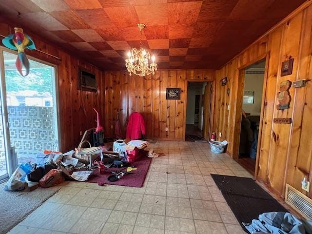 dining area with light flooring, wooden walls, a chandelier, and a wall mounted AC