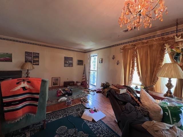 living area with a chandelier, wood finished floors, and ornamental molding