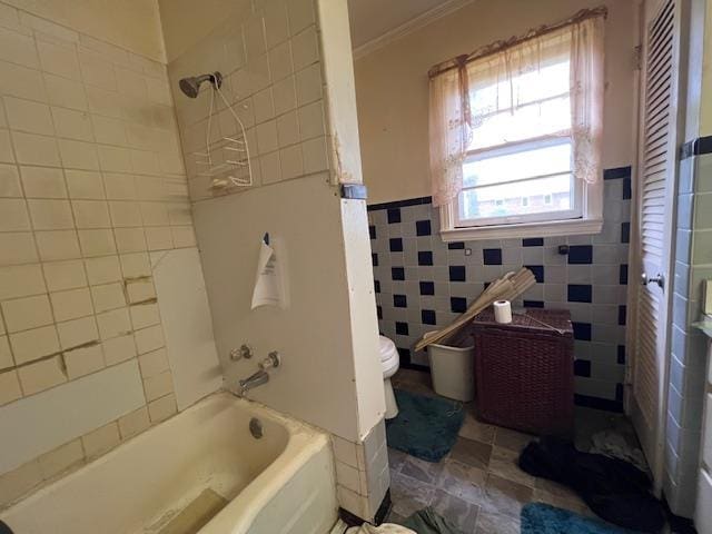 full bathroom with crown molding, toilet, tub / shower combination, and tile walls