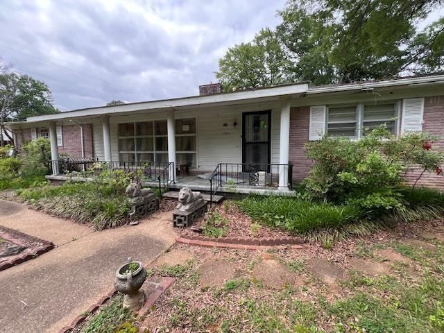 ranch-style home with covered porch and brick siding