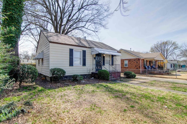 bungalow-style home featuring fence and a gate