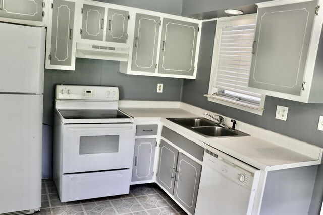 7206 N Juana Dr, Millington, TN 38053 - kitchen featuring white appliances, under cabinet range hood, a sink, light countertops, and tile patterned floors