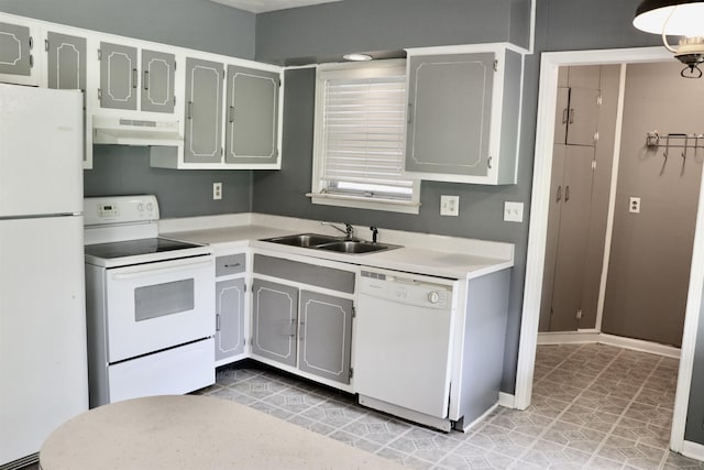 7206 N Juana Dr, Millington, TN 38053 - kitchen with white appliances, under cabinet range hood, a sink, and light countertops