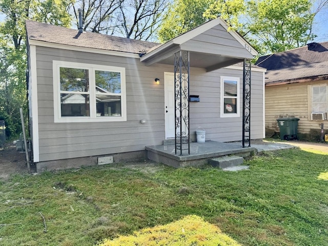 852 Marianna St, Memphis, TN 38114 - view of front facade with a front yard, crawl space, and cooling unit