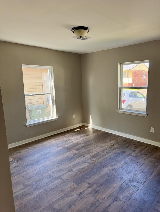 852 Marianna St, Memphis, TN 38114 - unfurnished room with dark wood finished floors, plenty of natural light, and baseboards