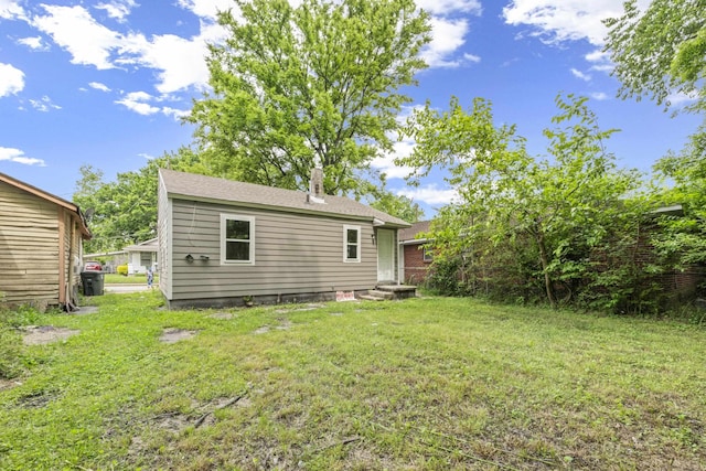 852 Marianna St, Memphis, TN 38114 - back of house featuring a yard and a chimney