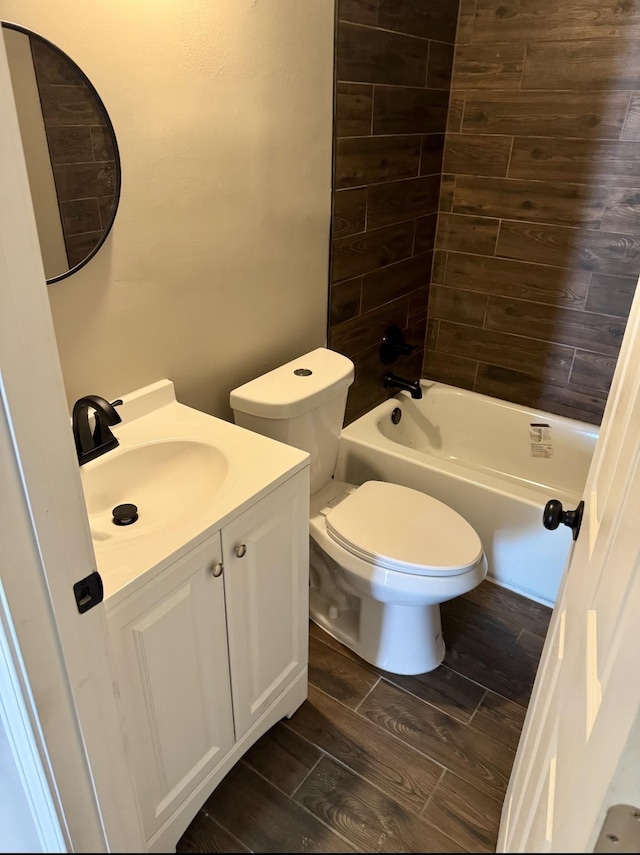 852 Marianna St, Memphis, TN 38114 - bathroom featuring wood finished floors, toilet, vanity, and shower / bathtub combination