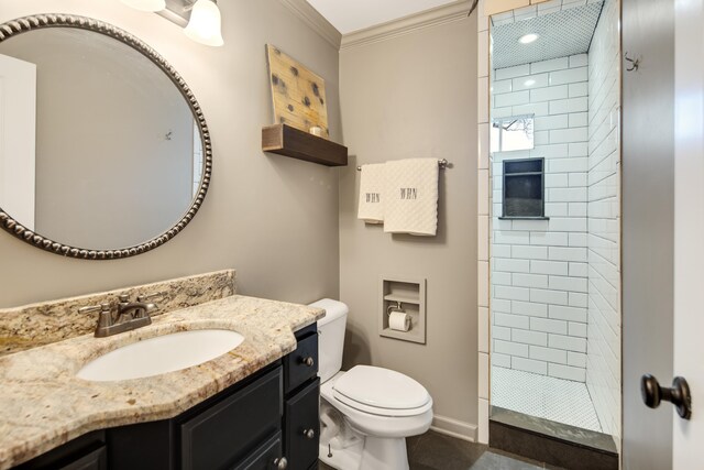 3850 Poplar Ave, Memphis, TN 38111 - bathroom with toilet, a tile shower, vanity, crown molding, and tile patterned floors