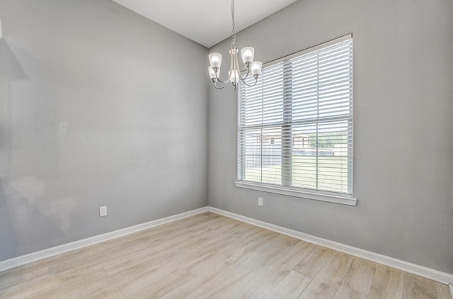 135 Briar Hollow Ln, Oakland, TN 38060 - unfurnished room featuring wood finished floors, a chandelier, and baseboards