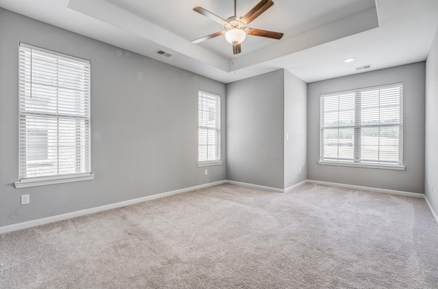 135 Briar Hollow Ln, Oakland, TN 38060 - carpeted empty room featuring a tray ceiling, baseboards, ceiling fan, and plenty of natural light