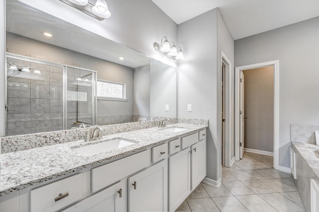135 Briar Hollow Ln, Oakland, TN 38060 - bathroom with a stall shower, tile patterned flooring, a bath, double vanity, and baseboards