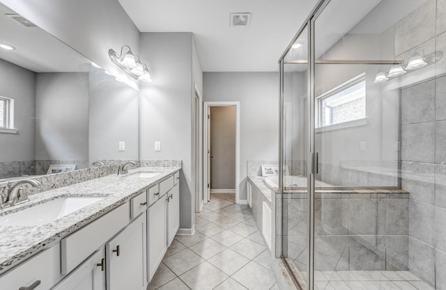 135 Briar Hollow Ln, Oakland, TN 38060 - full bathroom featuring a shower stall, tile patterned flooring, a garden tub, double vanity, and baseboards