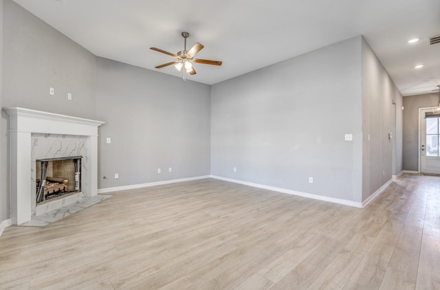 135 Briar Hollow Ln, Oakland, TN 38060 - unfurnished living room featuring ceiling fan, a fireplace, light wood-style flooring, baseboards, and recessed lighting
