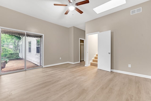 1793 Hayden Rd, Germantown, TN 38138 - spare room featuring a skylight, a ceiling fan, light wood-type flooring, and baseboards