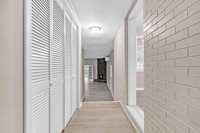 1793 Hayden Rd, Germantown, TN 38138 - hallway with light wood-style floors, brick wall, and baseboards