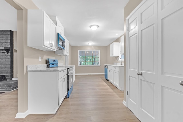 1793 Hayden Rd, Germantown, TN 38138 - kitchen with stainless steel appliances, light wood-style flooring, baseboards, and white cabinetry