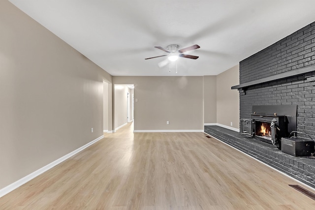 1793 Hayden Rd, Germantown, TN 38138 - unfurnished living room with a ceiling fan, wood finished floors, a fireplace, and baseboards