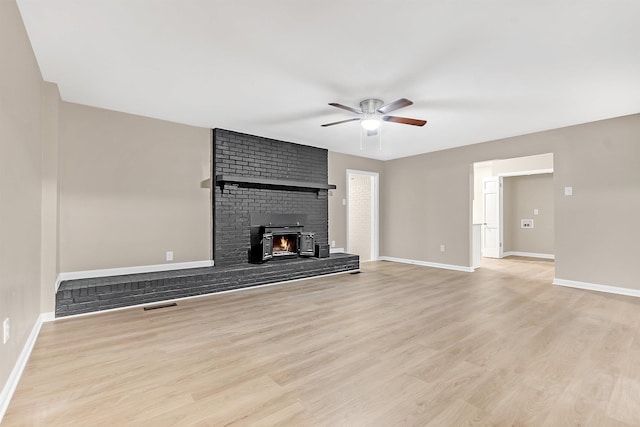 1793 Hayden Rd, Germantown, TN 38138 - unfurnished living room featuring a ceiling fan, light wood finished floors, and baseboards