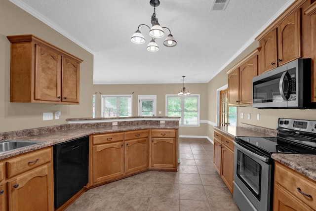 kitchen featuring appliances with stainless steel finishes, a chandelier, a peninsula, decorative light fixtures, and brown cabinets
