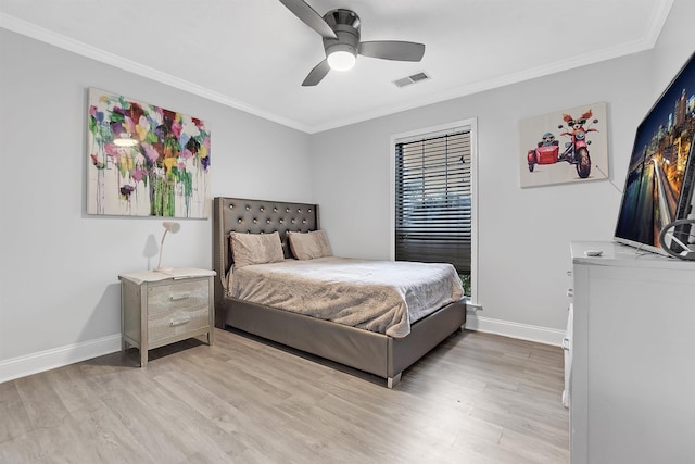 bedroom with ornamental molding, light wood-style flooring, baseboards, and a ceiling fan