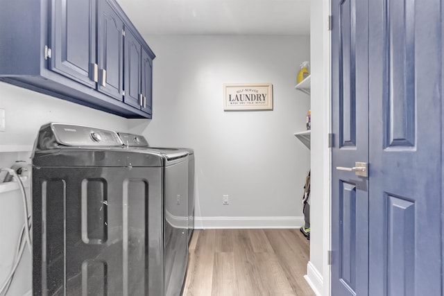 washroom with independent washer and dryer, light wood-style flooring, cabinet space, and baseboards
