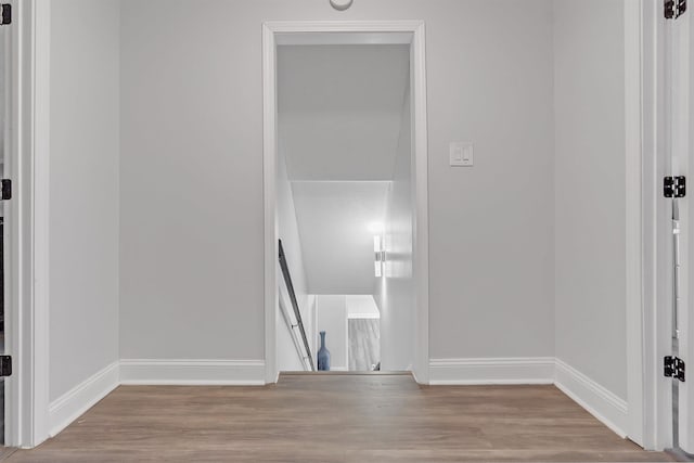 unfurnished room featuring baseboards and wood finished floors